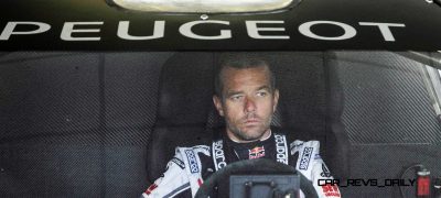 Sebastien Loeb wait while the engineers  and mechanics adjust the 208T16 for the first test track at the Peugeot test center in La Ferté-Vidame, France,  on April 18th, 2013