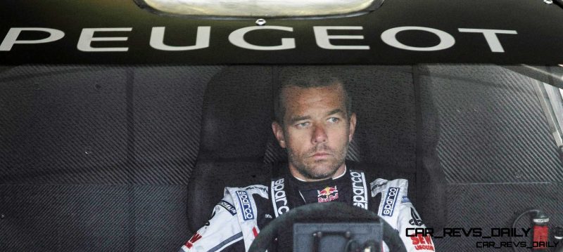 Sebastien Loeb wait while the engineers  and mechanics adjust the 208T16 for the first test track at the Peugeot test center in La Ferté-Vidame, France,  on April 18th, 2013