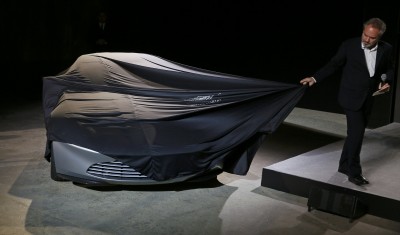 Director Sam Mendes unveils an Aston Martin DB10 car during an event to mark the start of production for the new James Bond film "Spectre" at Pinewood Studios